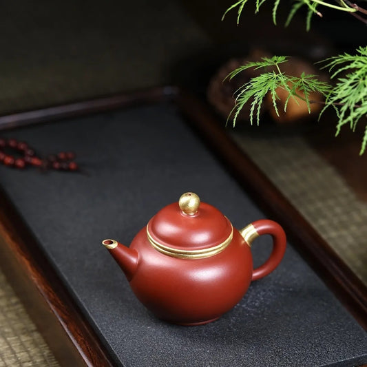 Product Name: Yixing Purple Clay Teapot - Masterfully Handcrafted Zhu Ni with Gold Outline, 200cc Capacity